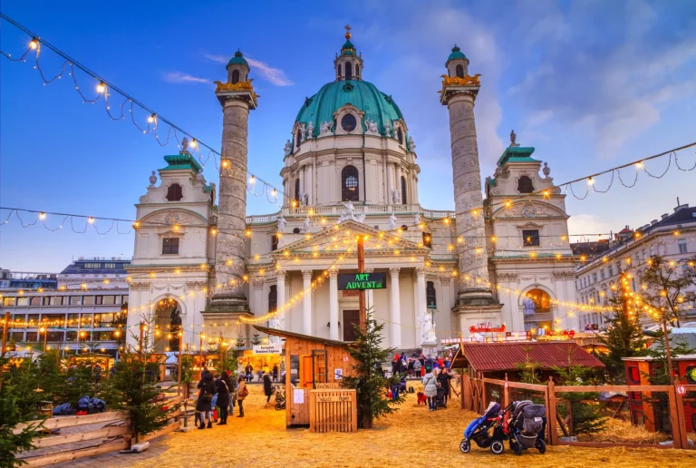 Festive cityscape - view of the Christmas Market on Karlsplatz (Charles' Square) and the Karlskirche (St. Charles Church) in the city of Vienna, Austria